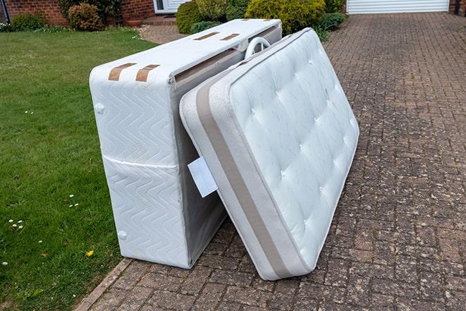 mattress being loaded onto removal truck